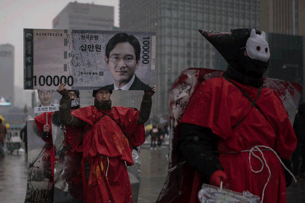 A protester carries a placard showing an image of Samsung heir Mr Lee during an anti-government protest in Seoul on Jan 21, 2017.